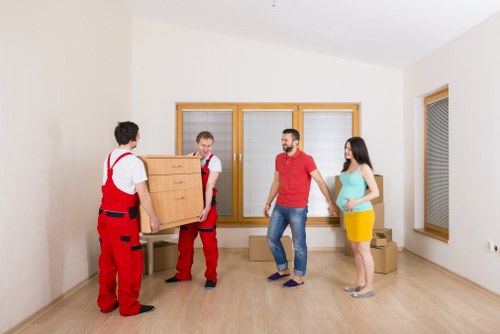 Local moving team handling boxes and furniture in Greenwich